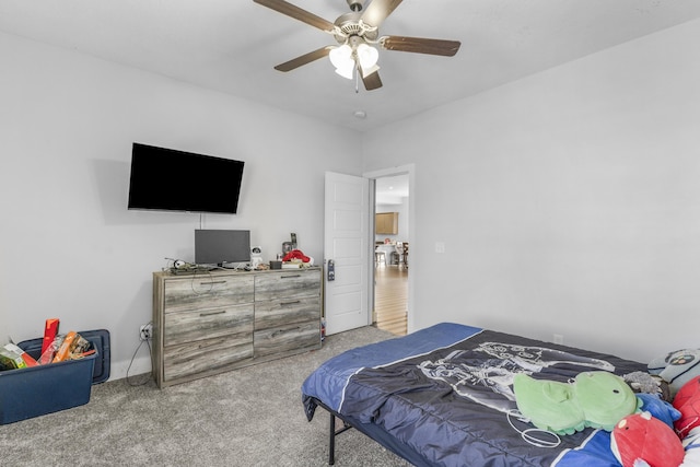 bedroom featuring ceiling fan and carpet