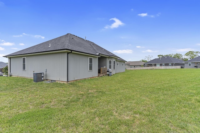 1360 N Rainbow Ct, Nixa, MO 65714 - rear view of property featuring central AC, a lawn, and a shingled roof