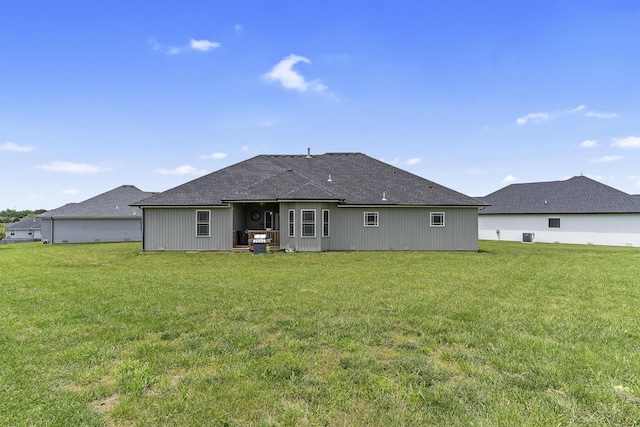 1360 N Rainbow Ct, Nixa, MO 65714 - rear view of property with a yard, a shingled roof, and central AC unit