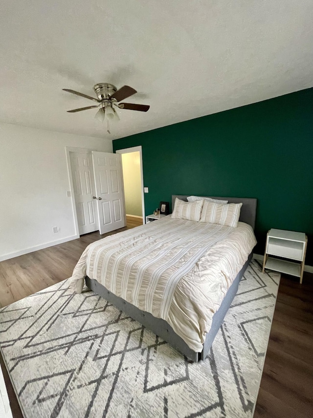 bedroom featuring ceiling fan and hardwood / wood-style floors