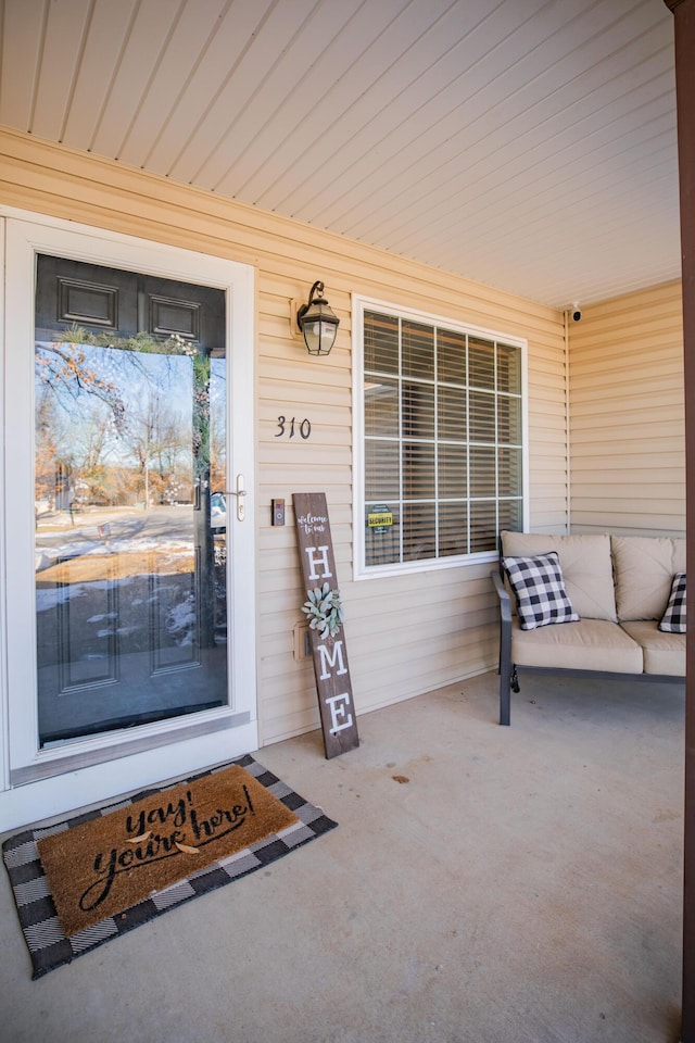 view of exterior entry with covered porch