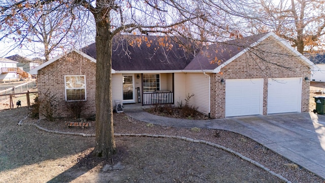 ranch-style house featuring a garage and covered porch