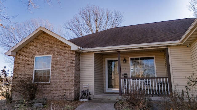 entrance to property featuring a porch