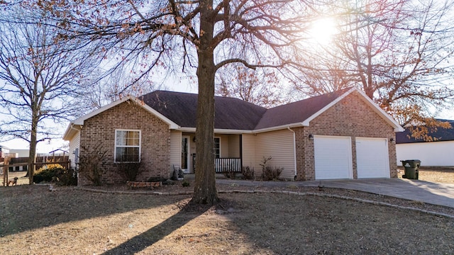 ranch-style house with a garage and covered porch