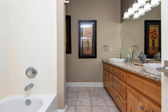 bathroom featuring tile patterned flooring, a tub, and vanity