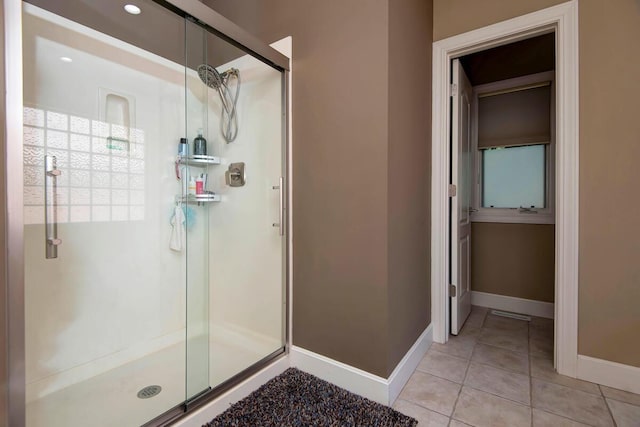 bathroom with walk in shower and tile patterned floors