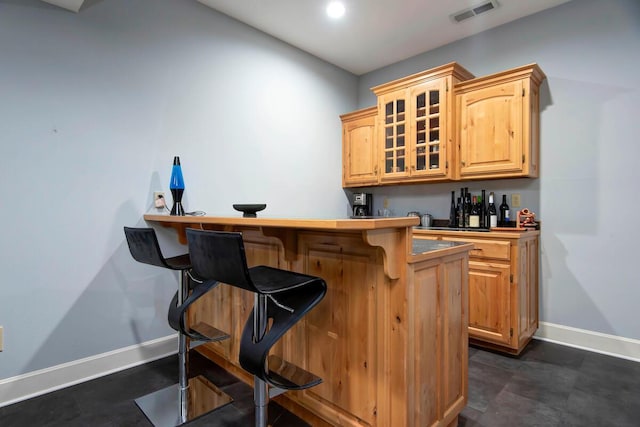 bar with light brown cabinetry