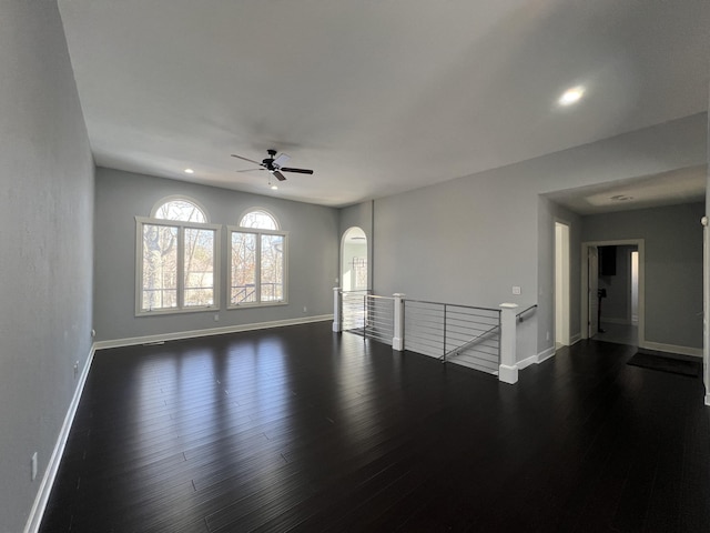 unfurnished room featuring ceiling fan and dark hardwood / wood-style flooring