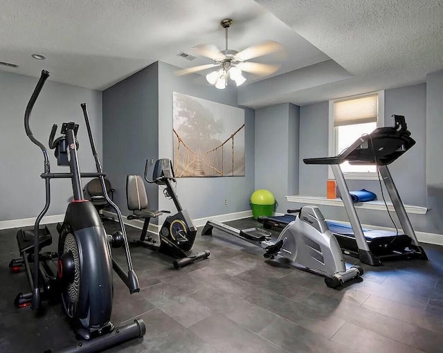 exercise area featuring a textured ceiling and ceiling fan