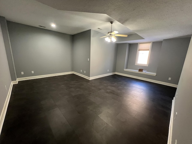 spare room with a textured ceiling and ceiling fan