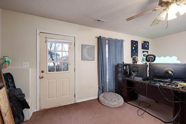 office area with ceiling fan, a textured ceiling, and carpet floors