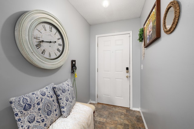 entryway with a textured ceiling