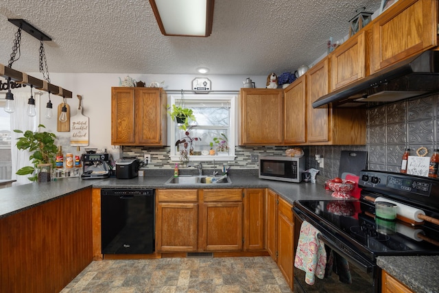 kitchen with a textured ceiling, black appliances, tasteful backsplash, sink, and hanging light fixtures