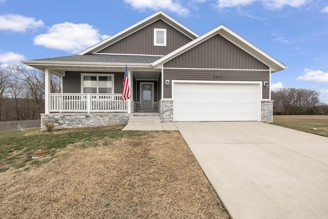 craftsman inspired home featuring a front yard, a garage, and a porch