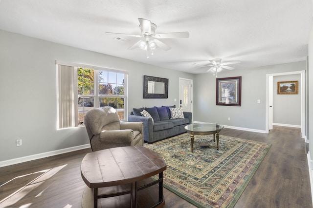 living area featuring dark wood-style flooring, visible vents, ceiling fan, and baseboards