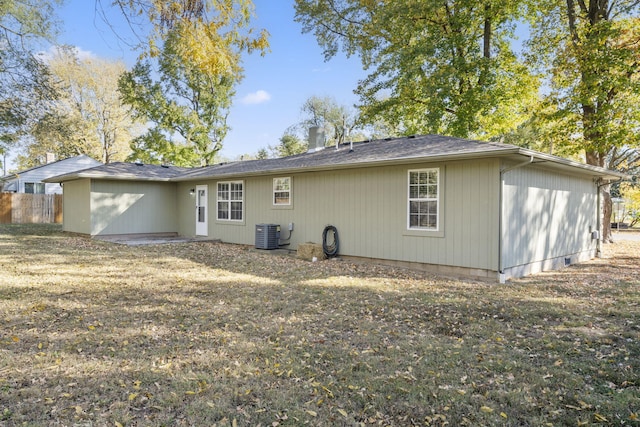 rear view of property with fence and central AC