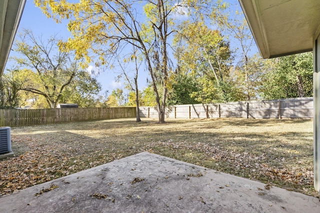 view of yard with a fenced backyard, cooling unit, and a patio