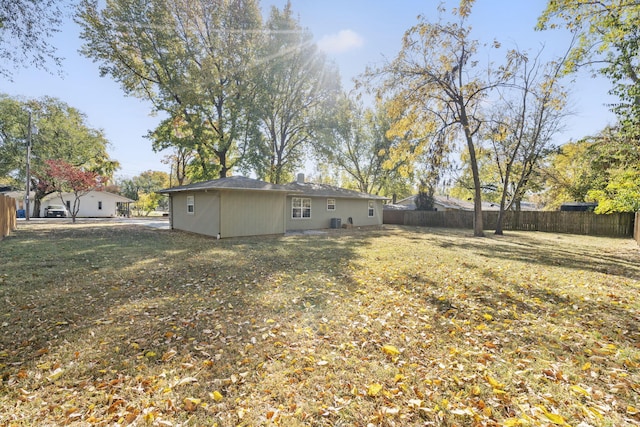 back of house featuring fence