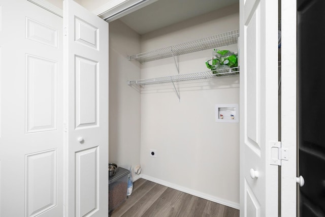 washroom featuring dark hardwood / wood-style floors, washer hookup, and electric dryer hookup