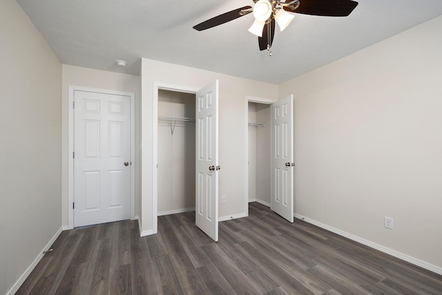 unfurnished bedroom with ceiling fan and dark hardwood / wood-style flooring