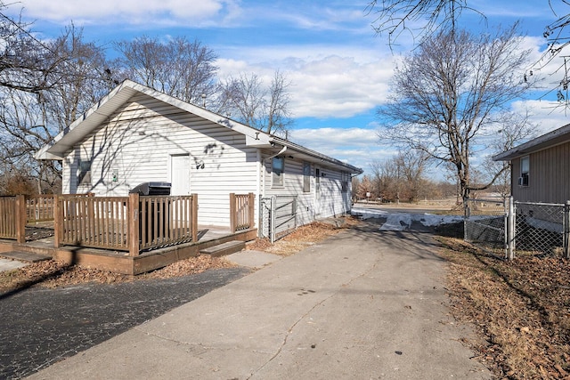 view of side of property with a wooden deck