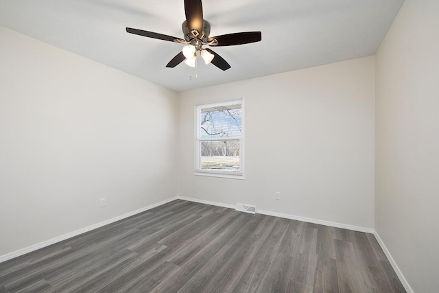 unfurnished room featuring ceiling fan and dark hardwood / wood-style flooring