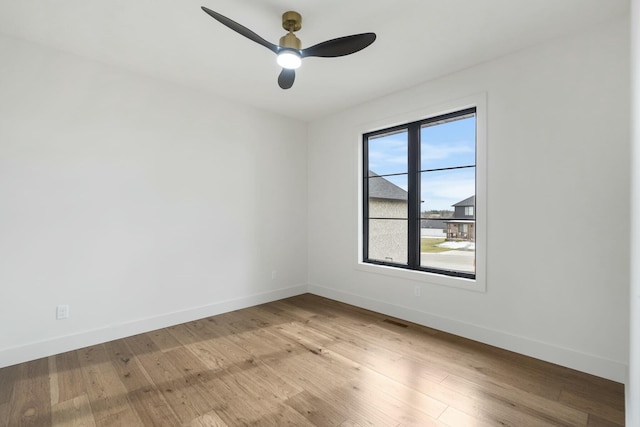 empty room with ceiling fan and light wood-type flooring