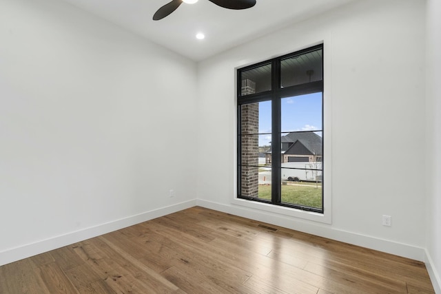 empty room with ceiling fan and wood-type flooring