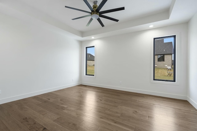 spare room featuring ceiling fan and dark hardwood / wood-style flooring