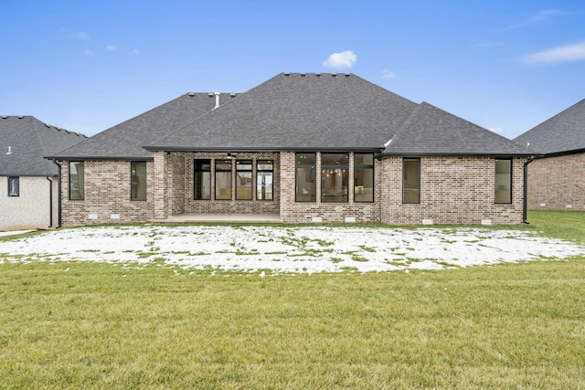 rear view of property with a yard