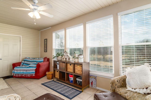 living area with wood ceiling, ceiling fan, and light tile patterned floors