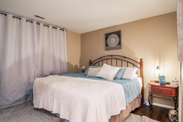 bedroom with dark wood-type flooring