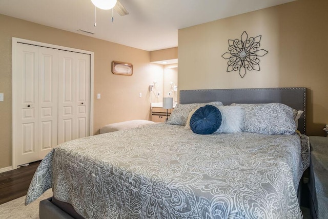 bedroom featuring hardwood / wood-style floors, a closet, and ceiling fan