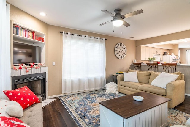 living room with ceiling fan and dark hardwood / wood-style floors