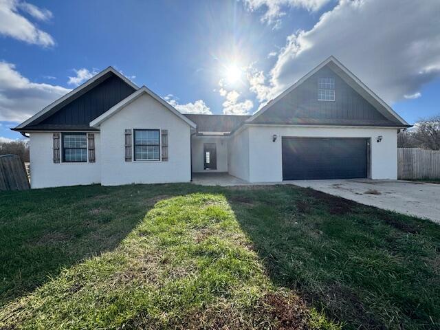 view of front of property with a front yard and a garage