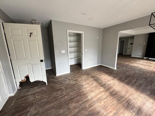 unfurnished bedroom with dark hardwood / wood-style flooring