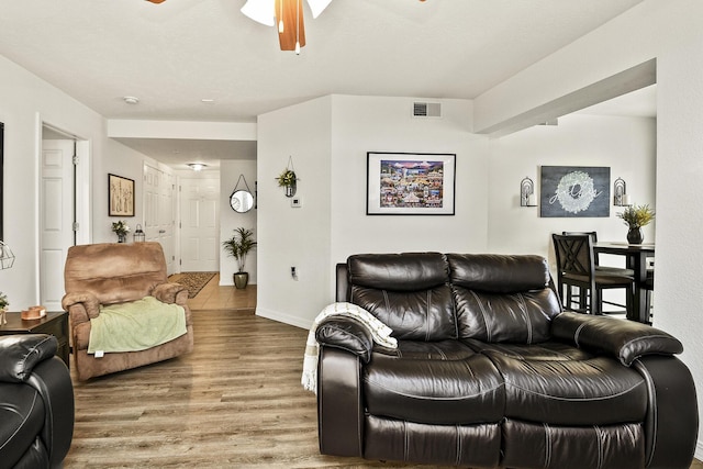 living room featuring ceiling fan and hardwood / wood-style floors