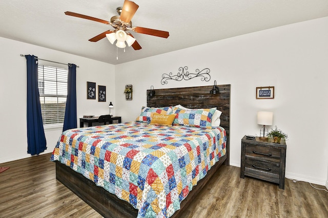 bedroom with ceiling fan and dark wood-type flooring