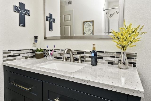 bathroom featuring backsplash and vanity