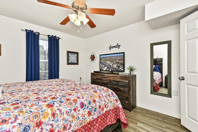 bedroom with ceiling fan and wood-type flooring