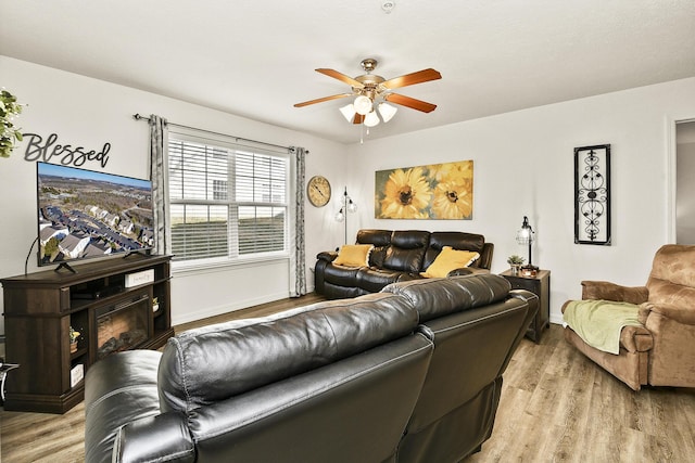 living room featuring ceiling fan and light wood-type flooring