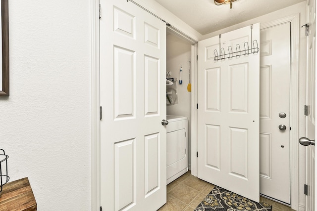 entryway featuring light tile patterned floors and washer / clothes dryer