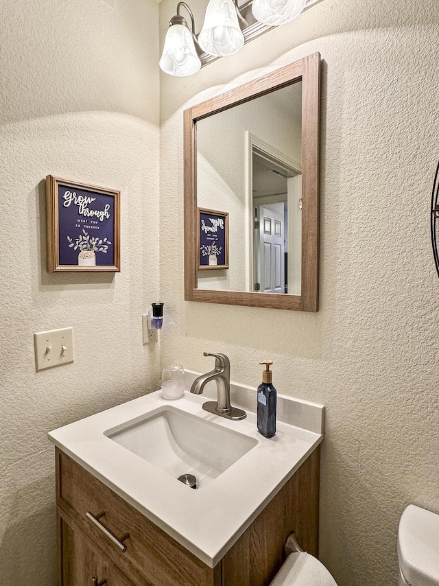 bathroom featuring toilet and vanity