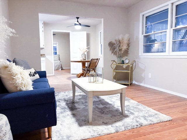 living room featuring ceiling fan and light wood-type flooring