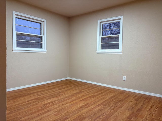 empty room with light hardwood / wood-style flooring