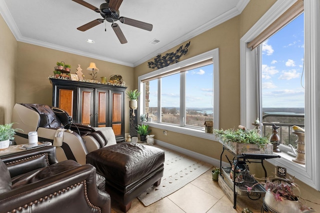 sitting room with ceiling fan, ornamental molding, and light tile patterned flooring