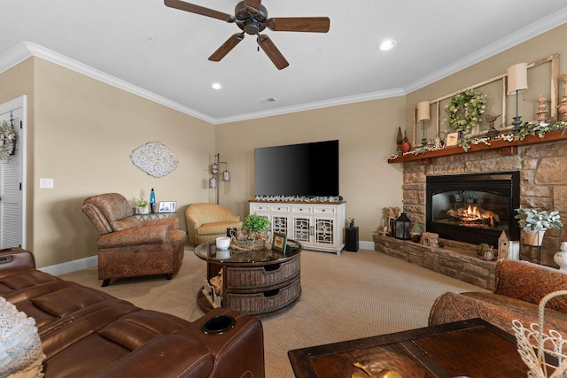 living room with ceiling fan, ornamental molding, a stone fireplace, and carpet flooring