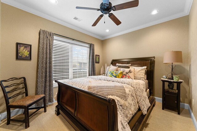 carpeted bedroom with ceiling fan and ornamental molding