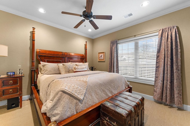 carpeted bedroom with ceiling fan and ornamental molding