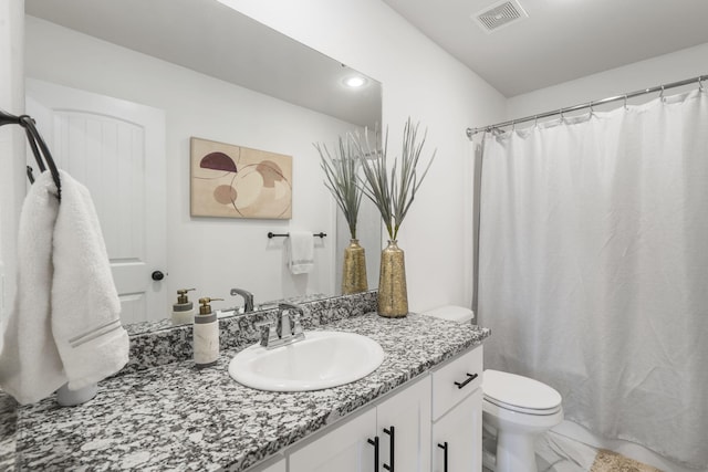 bathroom with toilet, a shower with shower curtain, and vanity